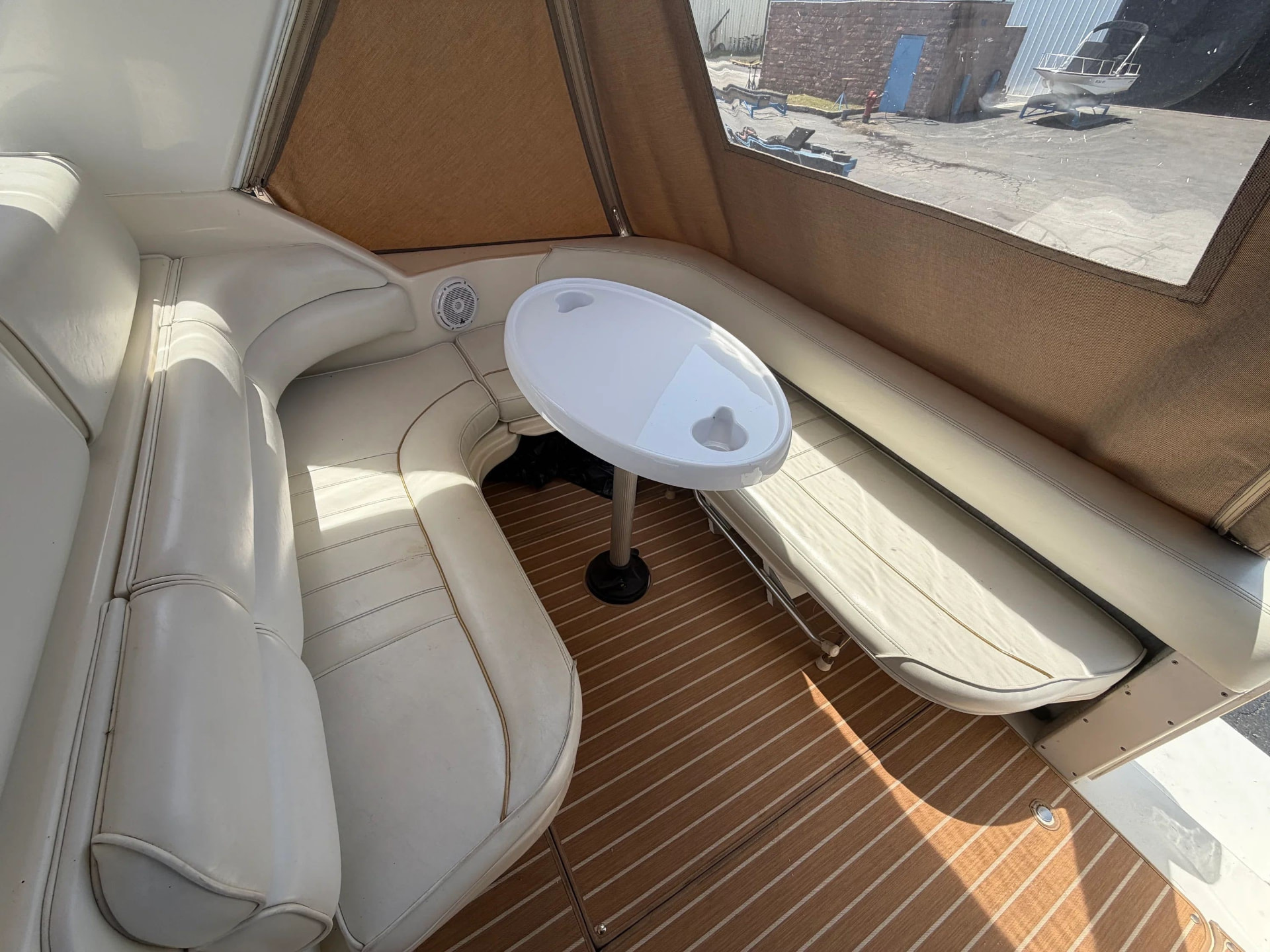 Cockpit lounge seating with wraparound cushions and a table aboard Francesca